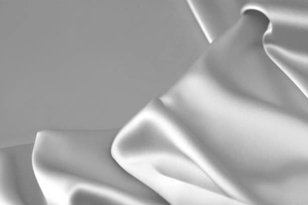 istock Rippled white silk fabric satin cloth waves background 1137350586