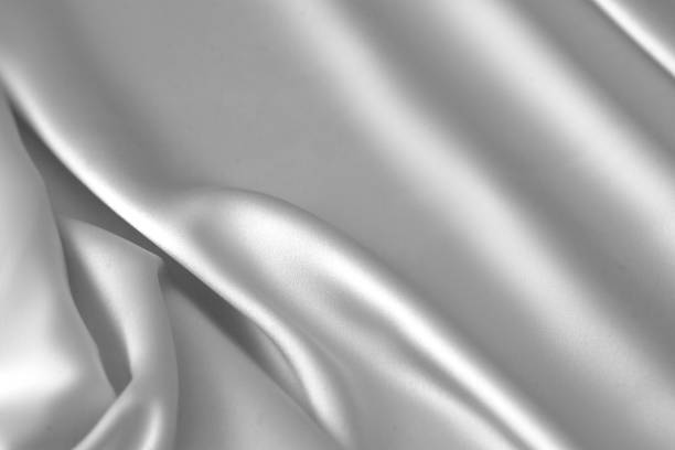 istock Rippled white silk fabric satin cloth waves background 1137350601