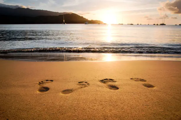 Footprints in the sand during sunset, Hanalei Bay Kauai, Hawaii