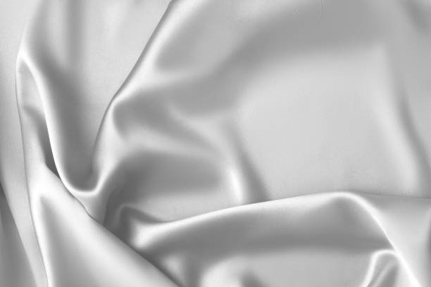 istock Rippled white silk fabric satin cloth waves background 1137350870