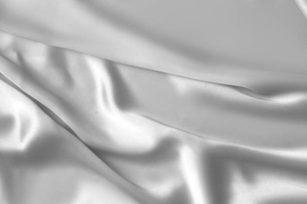 istock Rippled white silk fabric satin cloth waves background 1137350935
