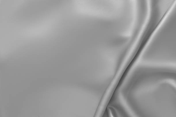 istock Rippled white silk fabric satin cloth waves background 1137350971