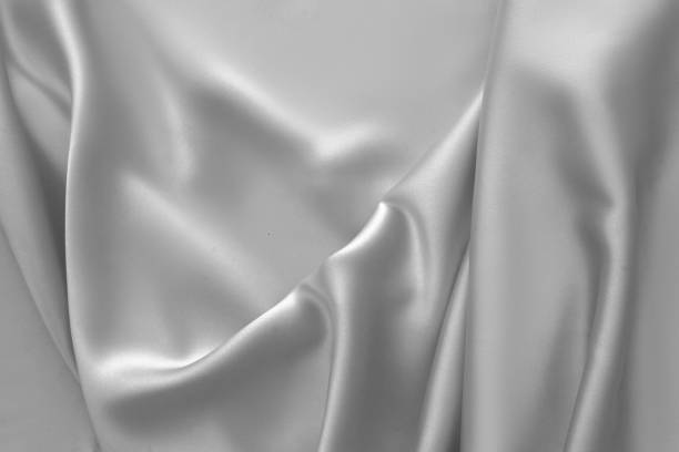 istock Rippled white silk fabric satin cloth waves background 1137351043