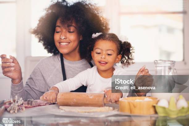 Mother And Daughter Are Baking Together Stock Photo - Download Image Now - Mother, Cooking, Baking