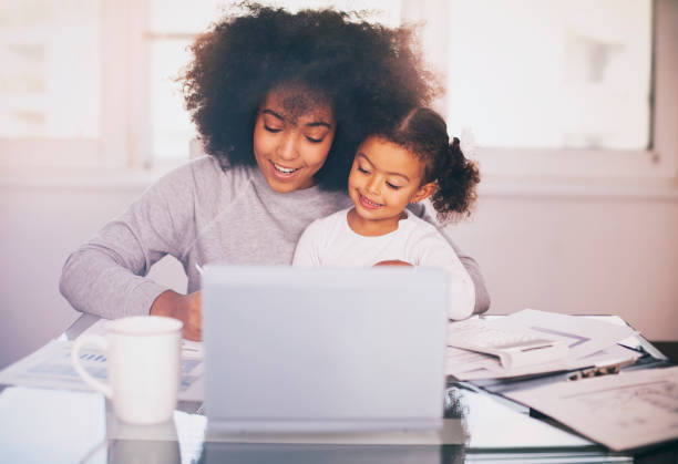 istock Young mother working and spending time with her daughter 1137352752
