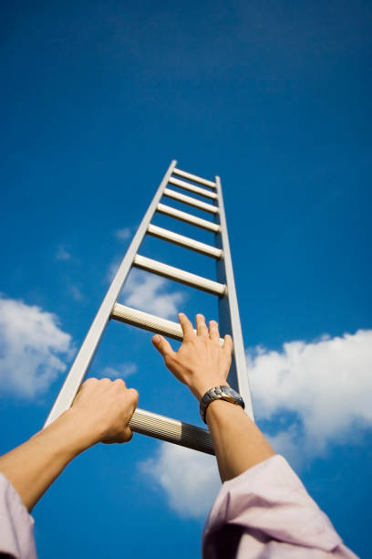 istock Businessman climbing a ladder 1137352829
