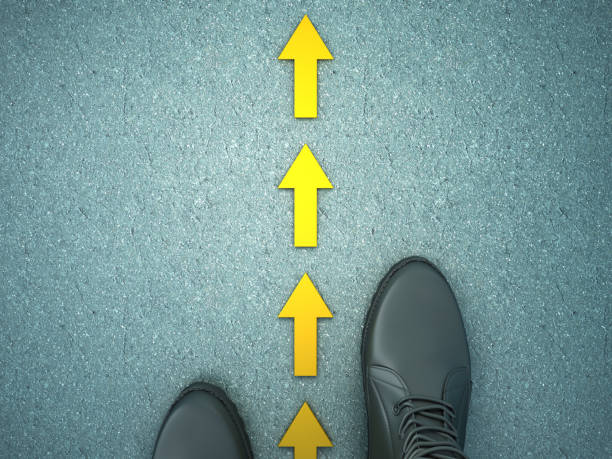 istock Feet on Asphalt Road with Arrows - 3D Rendering 1137353892