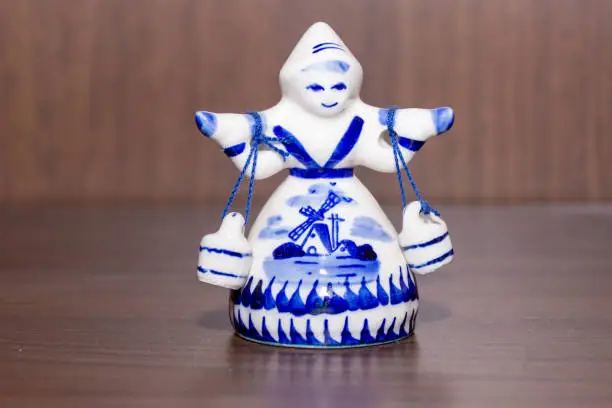 Photo of Delft Blue Figurine of girl carrying bells. Souvenir from Holland/Netherlands.