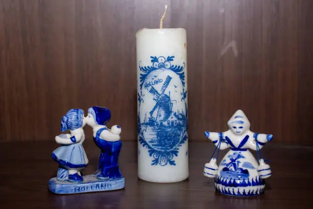 Photo of Delft Blue Figurine of girl carrying bells, kissing pair and candle. Souvenir from Holland/Netherlands.