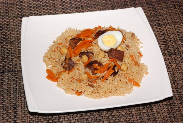 istock Rice with meat, carrot, vegetables and eggs on the top, also called as polaw, plov 1137355449