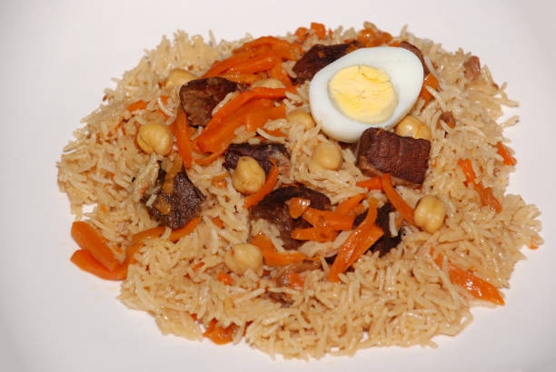 istock Rice with meat, carrot, vegetables and eggs on the top, also called as polaw, plov 1137355599