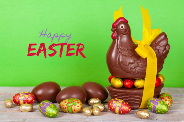 Easter chocolate chicken and eggs over a white rustic wooden table. The font used is free for commercial use.