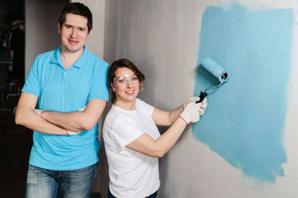 istock Young happy couple painting their new house interiors using paint rollers Home makeover and renovation concept 1137355988