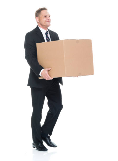 istock Businessman is walking and holding a box 1137359323