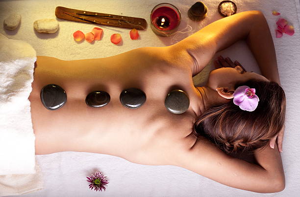 in the cosmetic salon.  hot stone massage stock pictures, royalty-free photos & images