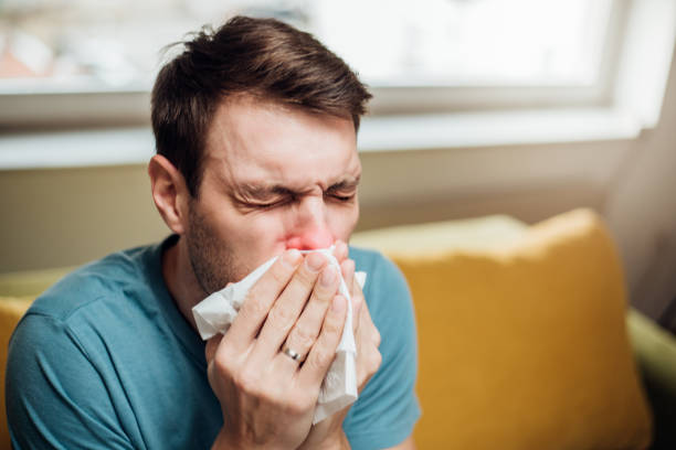 istock Man wiping his nose 1137359647
