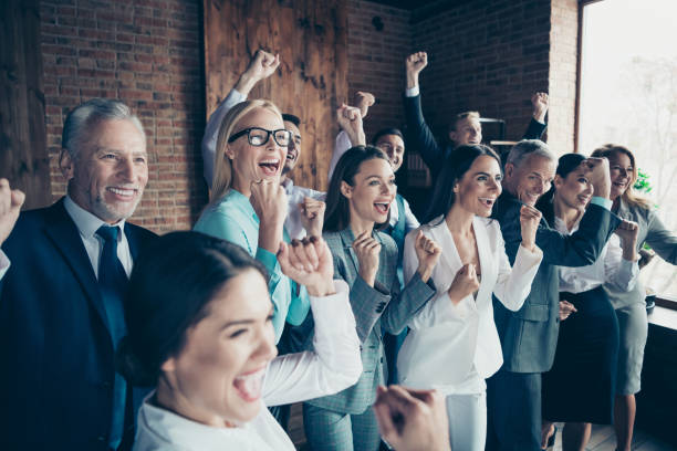 istock Close up side profile view photo diversity different age mixed race business people stand she her he him his best brigade hands arms raised project first place competition formal wear jackets shirts 1137360959