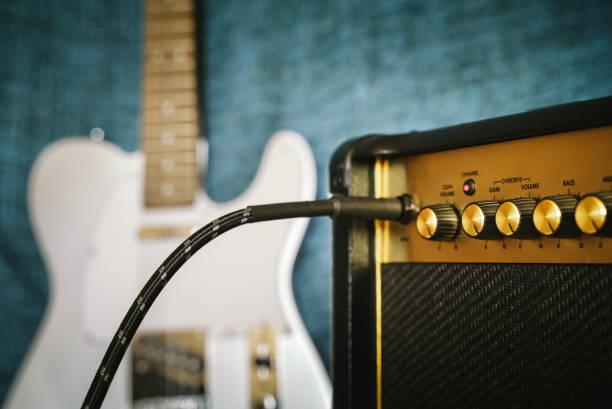 istock Guitar electric amplifier. Rock overdrive effect. Cable plugged into amp jack. Max volume control knob. Shallow depth of field 1137361335