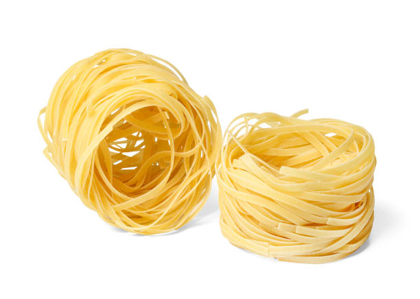 istock Noodles tagliatelle. One nest. White isolated background. 1137361375