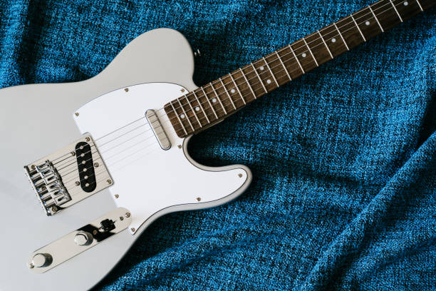 istock Guitar electric rock background. Top view on blue textile cloth 1137362393