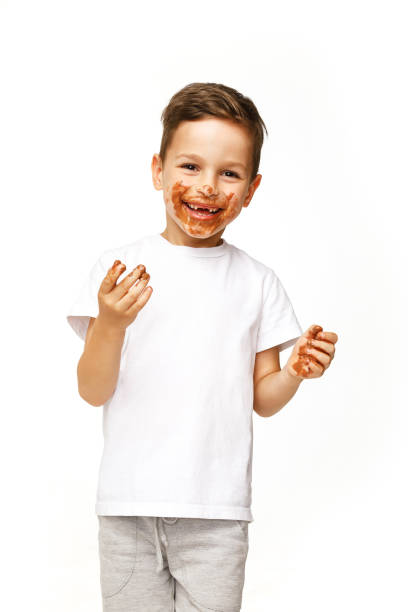 istock little boy with face and hands in chocolate 1137363337