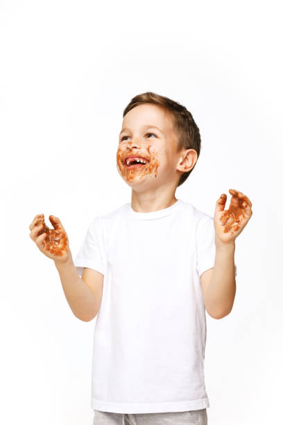 istock little boy with face and hands in chocolate 1137363909