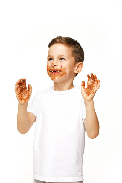 istock little boy with face and hands in chocolate 1137364092