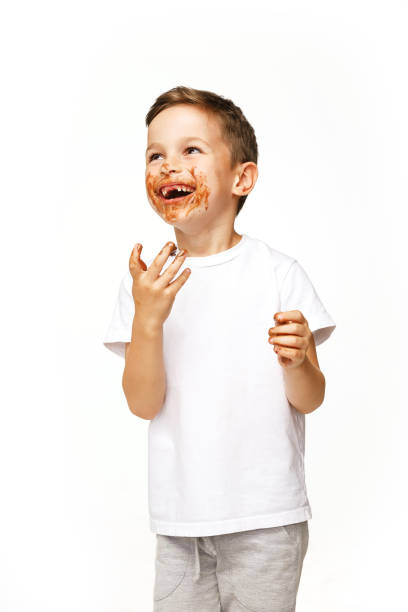 istock little boy with face and hands in chocolate 1137364157