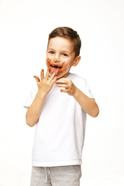 istock little boy with face and hands in chocolate 1137364200