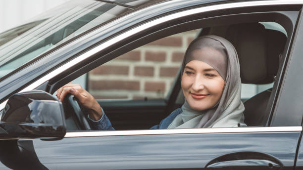 istock Muslim woman driving black luxury car 1137366208