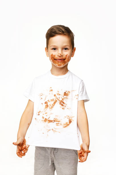 istock little boy with face and hands in chocolate 1137367271