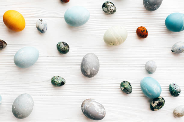 istock Stylish Easter eggs flat lay on white wooden background. Modern colorful easter eggs painted with natural organic dye. Happy Easter greeting card. Easter creative pattern 1137367574