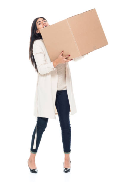 istock Attractive young latino female is holding a box 1137368101