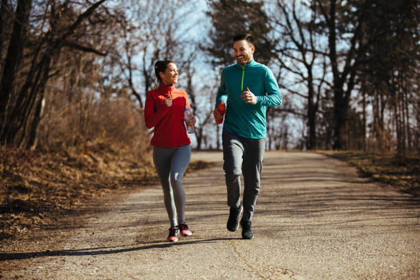 istock Athletic couple jogging in nature 1137369001