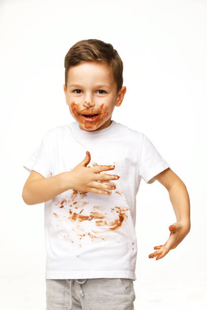 istock little boy with face and hands in chocolate 1137370470