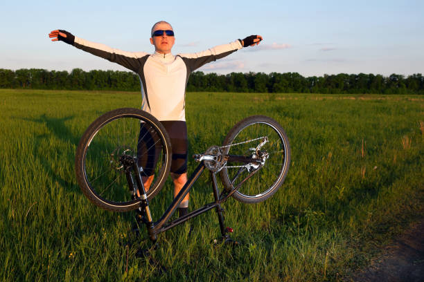 istock the cyclist with arms raised in the sun 1137370535
