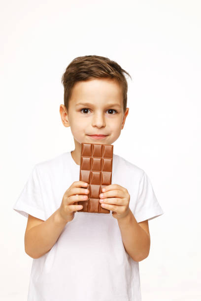 istock little beautiful boy holding chocolate studio shot 1137372241