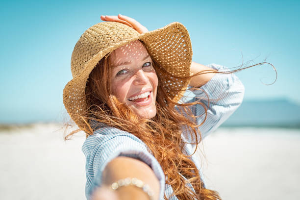 istock Smiling mature woman with straw hat 1137373542