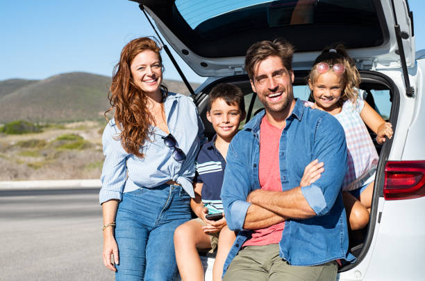 istock Family sitting in car trunk 1137373614