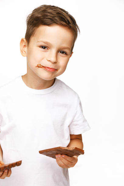 istock little beautiful boy holding chocolates studio shot 1137373617
