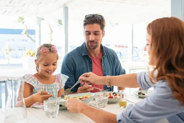 Photo of Mother serving daughter lunch