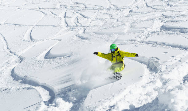 istock Man snowboarding at snow background 1137373998