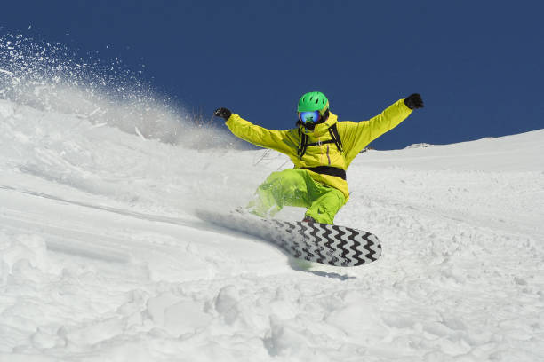 istock Young man snowboarding on powder day 1137374022