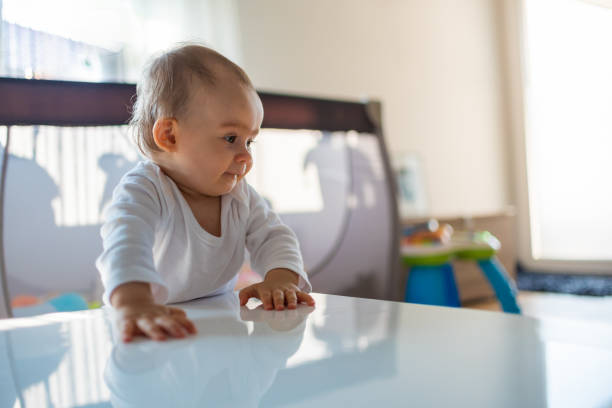 istock Caucasian baby girl based on a table in bright room 1137375246