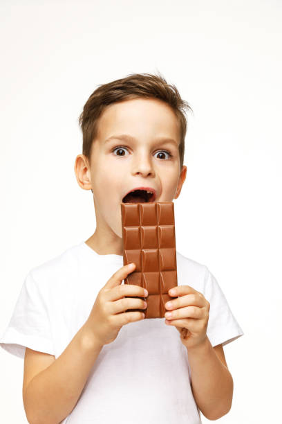 istock little beautiful boy holding chocolate studio shot 1137375300