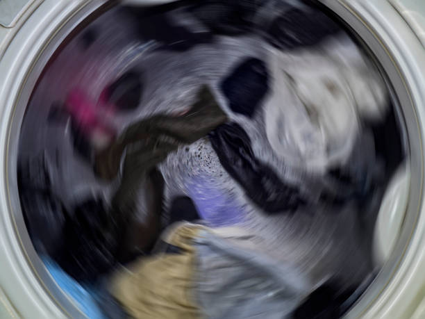 istock Top loading washing machine washes laundry. Internal view of a washing machine drum during wash. Top view. 1137376400
