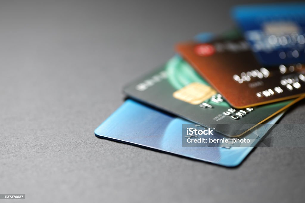 Stacked credit cards stack of multicolored credit cards on black background Credit Card Stock Photo