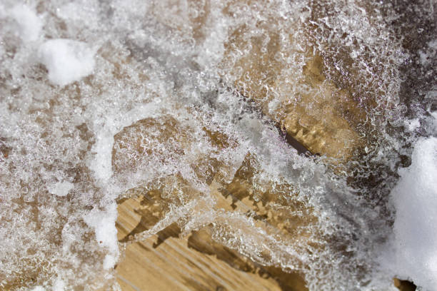 istock Macro abstract of melting snow on a wood surface in early spring 1137376800