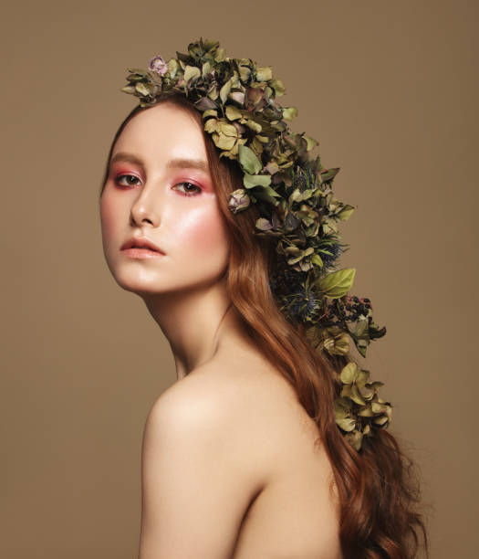 istock Beautiful young woman and flowers 1137378412