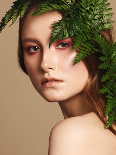 istock Beautiful young woman and leaves 1137378469